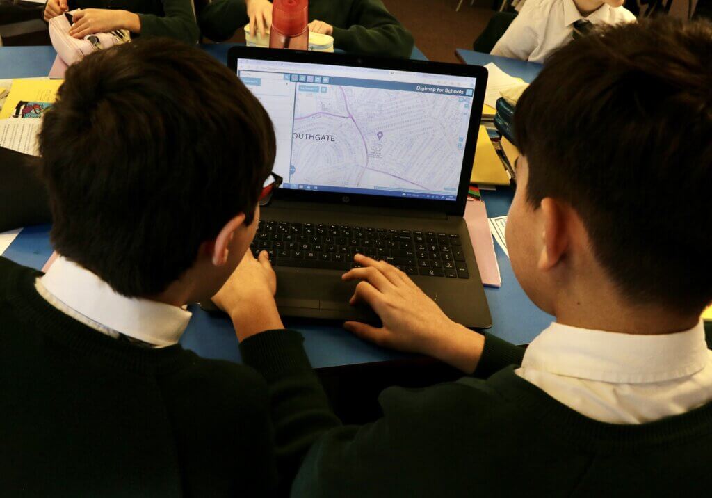 St Monica's pupils looking at laptop